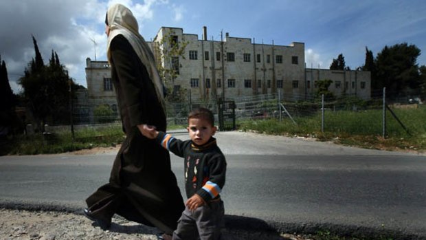 A Palestinian woman and child walked past the former Hotel Shepherd in east Jerusalem.