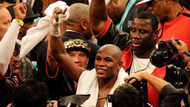 Floyd Mayweather Jr celebrates after defeating Shane Mosley by unanimous decision.