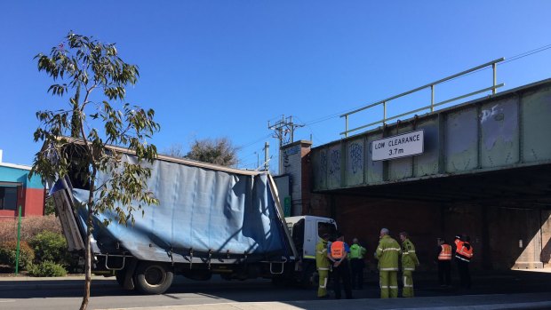 The truck knocked the bridge and had to be towed away.