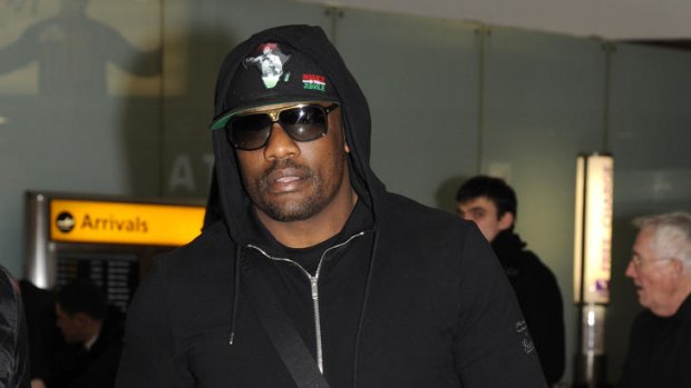 Sorry ... Dereck Chisora arrives back at Heathrow Airport.
