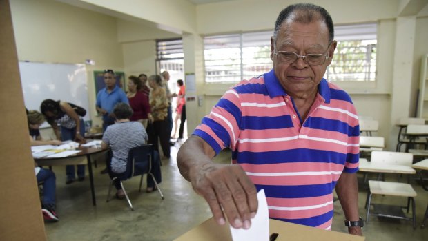 Puerto Rico resident Hector Alvarez casts his ballot during the US territory's Democratic primary election.