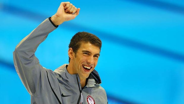 Another gold ... Michael Phelps celebrates on the medal dais.