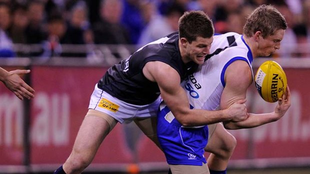 Wrapped up: Carlton's Bryce Gibbs tackles North's Jack Ziebell last night.