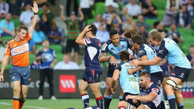 Match winner: Waratahs players celebrate Dave Horwitz's try to seal the match against the Rebels in Melbourne on Friday night.