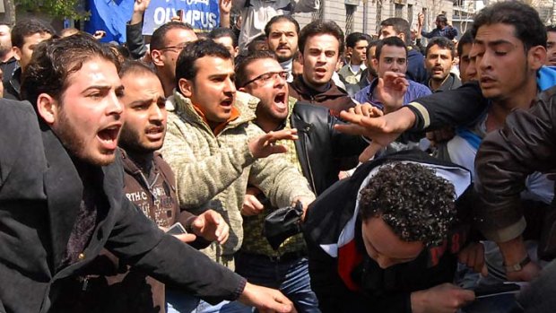 Unrest ... pro- and anti-government protesters clash in Syria.