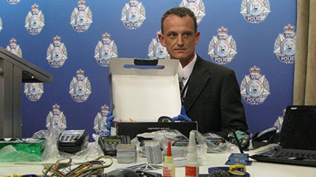 Detective Sergeant Duncan Taylor with some of the equipment seized in the raids.
