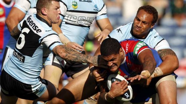 Impenetrable in defence: Newcastle's Willie Mason is held off Cronulla's line.