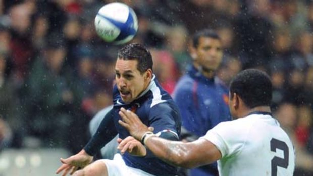 France's Julien Arias  (L) kicks the ball in front of Fiji's hooker Talemaitoga Tuapatu.