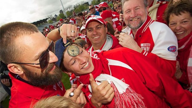 Nick Malceski poses with fans at Lakeside Stadium after the 2012 grand final victory.