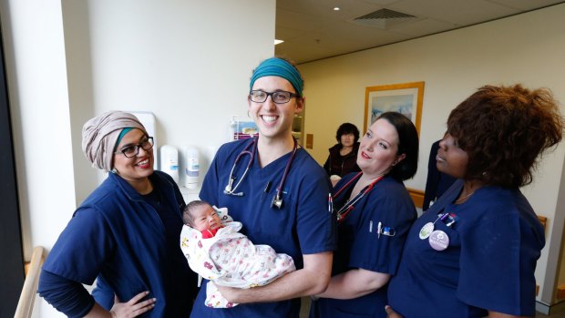 Nurse/midwife, Cameron Littlewood at Westmead Hospital holding one-day-old Lilian, with his colleagues , Sabah Scheiwani, Caragh Myers and Catherine Seay. 