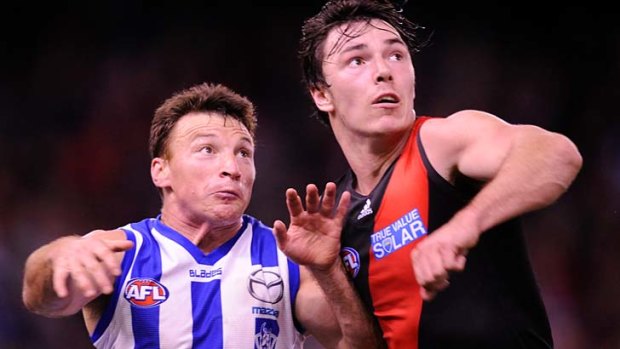 Bounding: Brent Harvey (left) proved a handful for Michael Hibberd, kicking three goals in as many minutes.