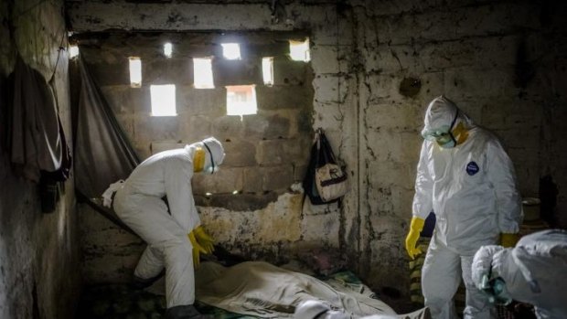 Members of an Ebola burial team at work in the Liberian capital Monrovia on September 6.