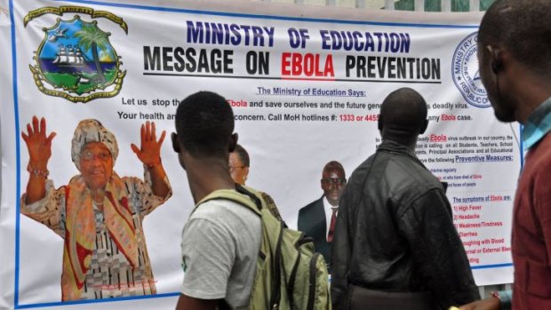 The image of Liberia President Ellen Johnson Sirleaf (left) appears on a banner warning people about the Ebola virus in the city of Monrovia, Liberia, on Friday.