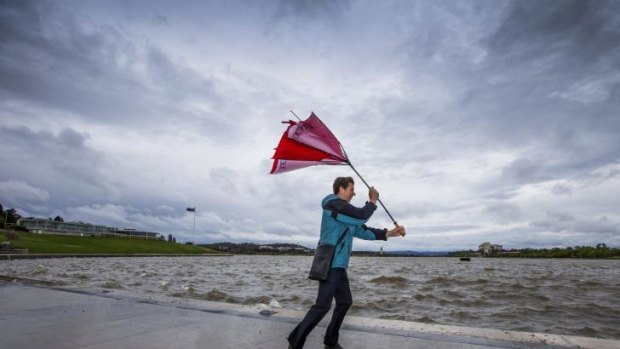 Hugh Lennon battles gale-force winds and rain during his walk home on Tuesday