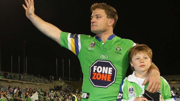Simon Woolford of the Raiders farewells the Canberra crowd with his son Zac, in 2006.