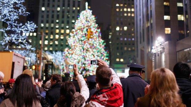 Spectators enjoy the celebration during 81st Annual The Rockefeller Centre Christmas tree lighting ceremony at Rockefeller Centre, in New York City.
