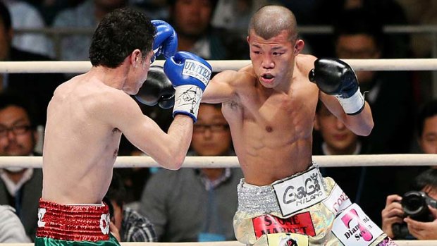 Japan's Koki Kameda (right) lands a right on Hugo Ruiz of Mexico during the World Boxing Association (WBA) bantamweight title match in Osaka.