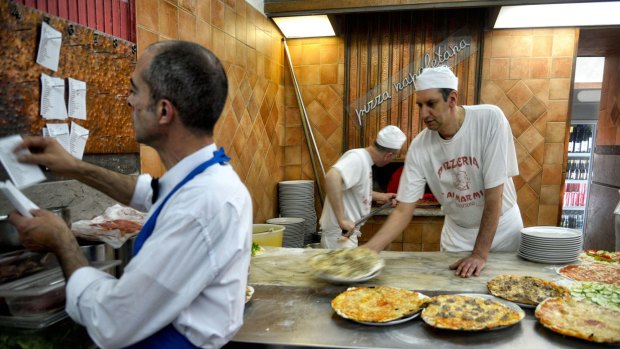 Rome’s Ai Marmi eatery serves traditional thin-crust pizzas.