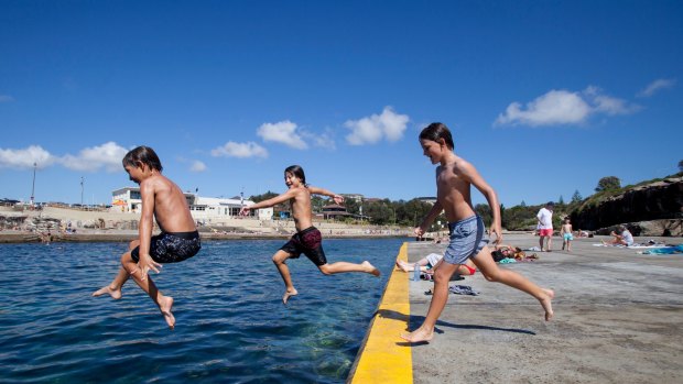 Crossing the line: (left to right) 10 year olds Bodie Taylor, Arki George, and Frankie Parsons jump in the ocean at Clovelly.