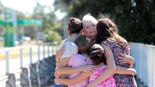 The four Sunshine Coast girls, now missing, comforted by a relative.