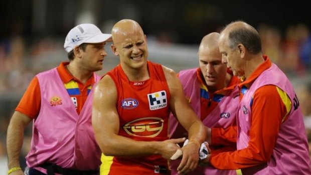 Gary Ablett leaves the field with an injury during the match against Collingwood on Saturday.