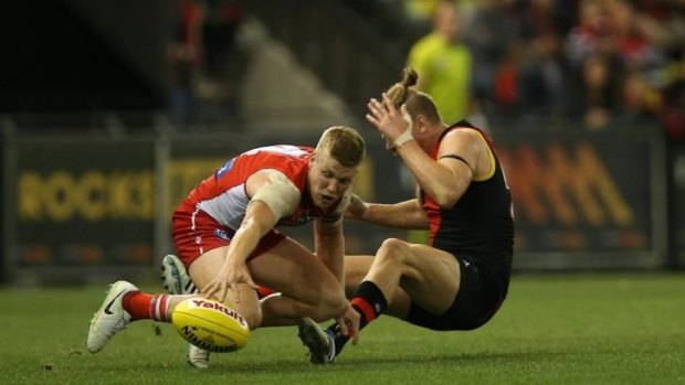 Collision course: Dan Hannebery and Michael Hurley collide in Friday night's game at Etihad.