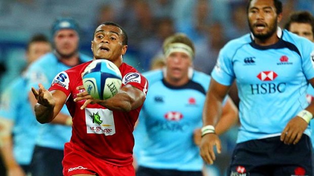 Deadeye . . . Queensland halfback Will Genia fires a pass to his backline in the Super Rugby game against NSW.