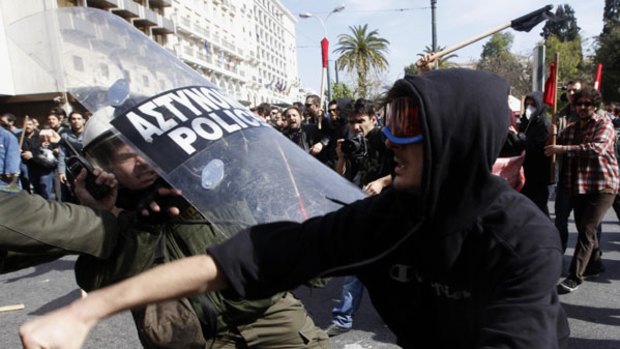 Anger over the government’s austerity measures ... protesters in Athens clash with riot police on Wednesday.