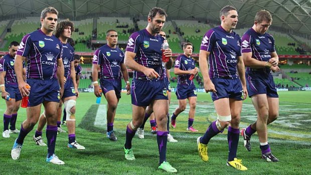 Off the boil: Cameron Smith leads his teammates off the field after their loss to the Raiders.