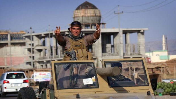 Confident: Iraqi Kurdish fighters take on the Islamic State.