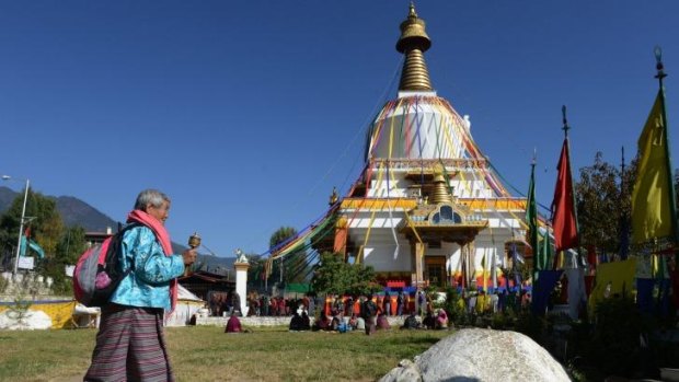 A Bhutanese Buddhist devotee walks near the Memorial Chorten Monastery in Thimphu.The once isolated country of Bhutan can now be viewed using Google's Street View.