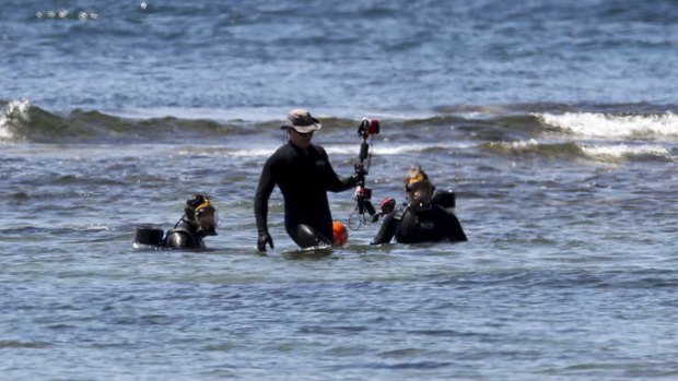 Police divers search for evidence after a scuba diver drowned.