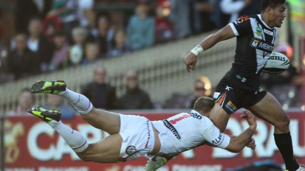 Poor form: Jason Nightingale tackles Wests Tigers centre Tim Simona in round 24.