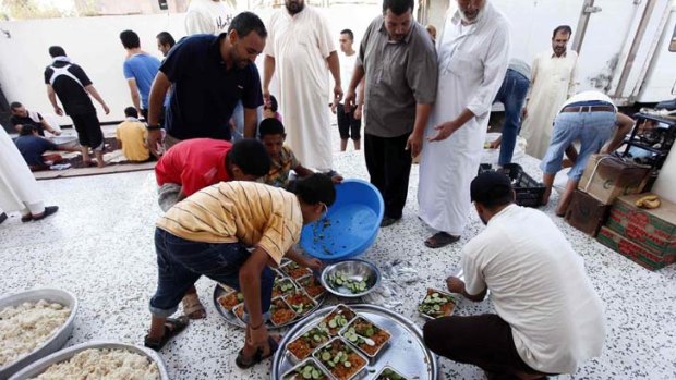 In limbo ... Janzour residents prepare food for Libyan rebels last week.