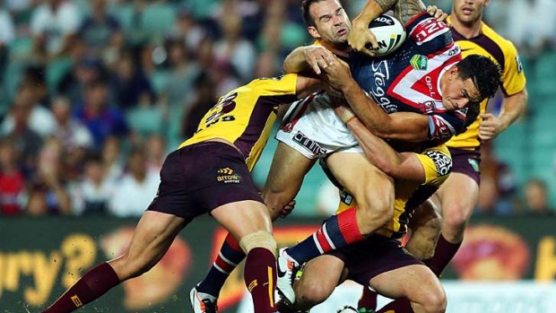 Sonny Bill Williams of the Roosters takes on the Broncos' defence.