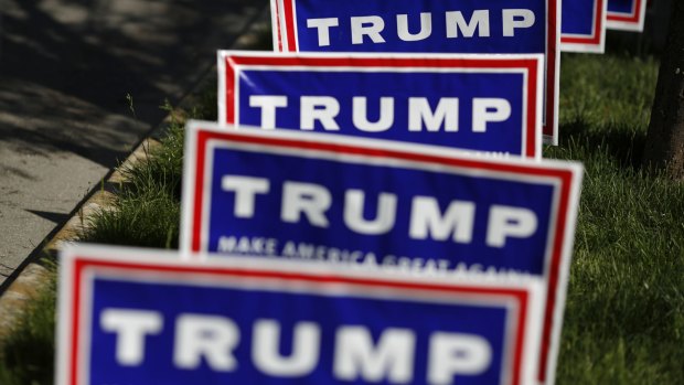 Signs are displayed outside a campaign event for Donald Trump in Evansville, Indiana.