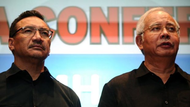 Najib Razak, right, at a press conference responding to the disaster.