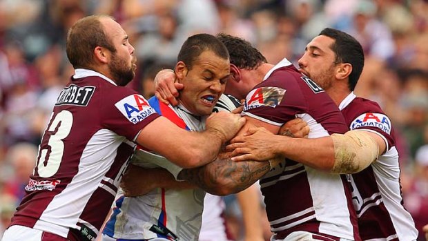 Locke up . . . Manly players block Knights prop Evarn Tuimavave at Brookvale yesterday. The aggressive Sea Eagles defence soon had Newcastle looking for soft options.