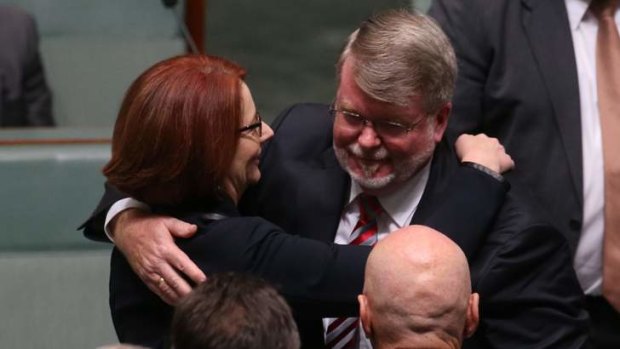 Former speaker Harry Jenkins is hugged by Prime Minister Julia Gillard after he delivered his valedictory speech at Parliament House.