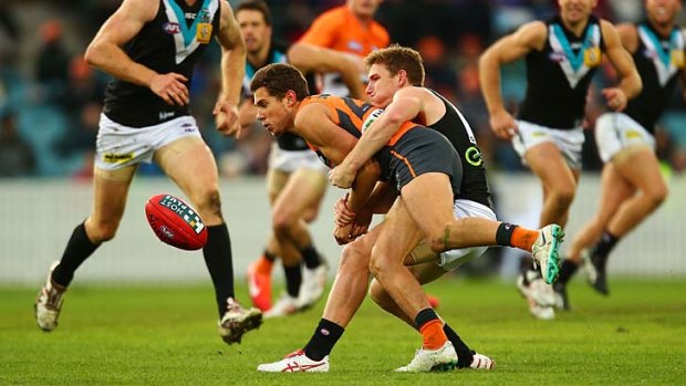 Josh Kelly of the Giants is tackled by Matt White of the Power during the round seven match in Canberra on Saturday.