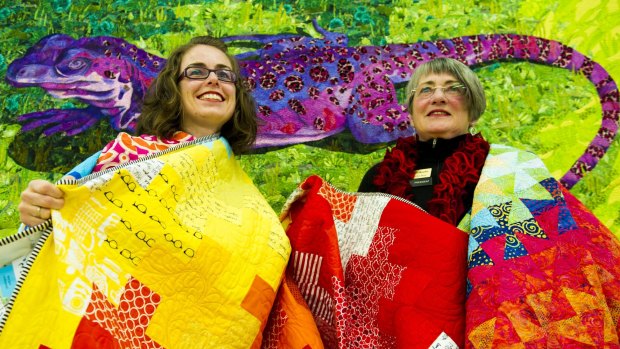 Canberra Quilters member Gemma Jackson, left, and president Helen Rose preparing for the quilt show.