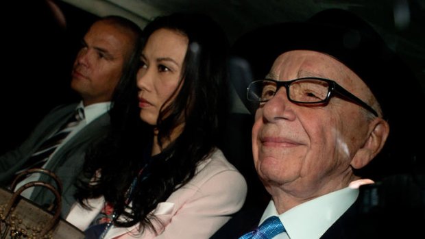 Second day of the inquiry ... News Corp chief Rupert Murdoch (right) his wife Wendi Deng (centre) and son Lachlan (left) leaving their London home yesterday.