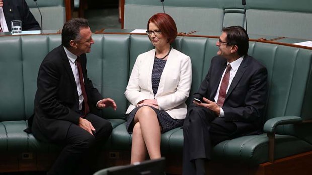 Prime Minister Julia Gillard talks with Craig Emerson and Greg Combet during a division in Parliament on Wednesday.