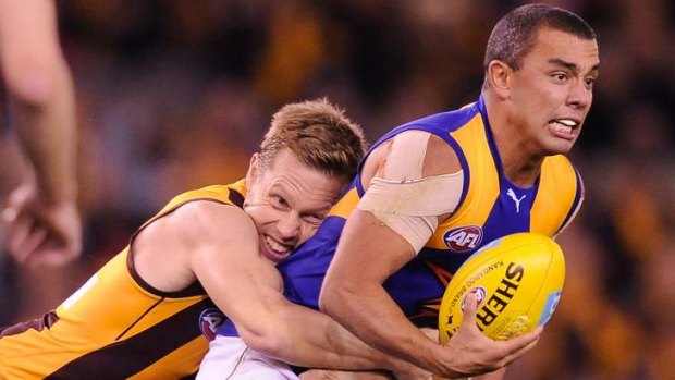 Eagle's Daniel Kerr tackled by Hawthorn's Sam Mitchell at Etihad Stadium in June.