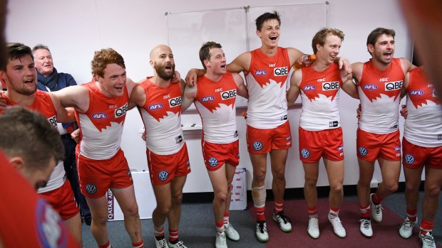 Sweet music: The victorious Swans belt out the team song.