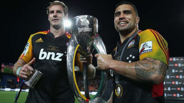 Craig Clarke and Liam Messam of the Chiefs pose with the Super Rugby trophy last year.