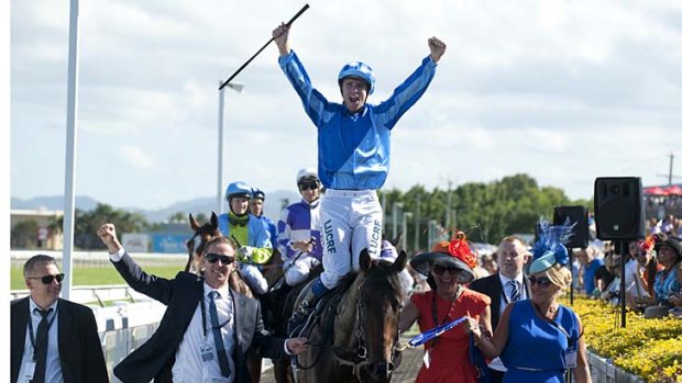 Jockey Nathan Berry celebrates after riding Unencumbered to victory.