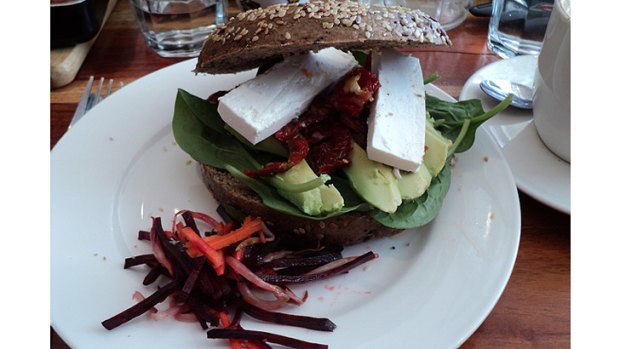 The health bagel - topped with greens, avocado, feta and sundried tomatoes with a side salad of julienne carrot and beetroot