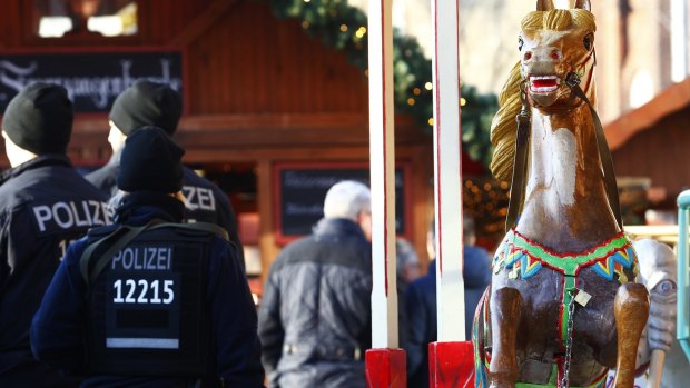 Police patrol a Christmas market the day it reopened following the attack.