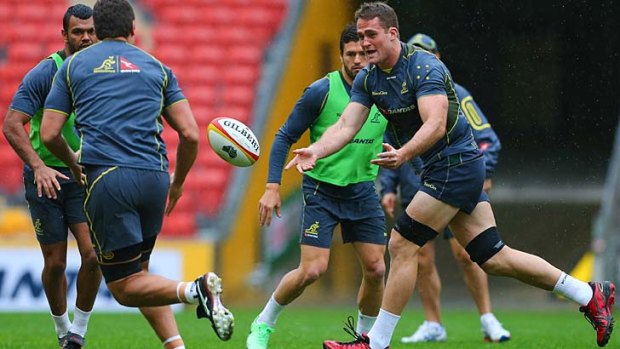 Wallabies captain James Horwill gets a pass away during the captain's run at Suncorp Stadium on Friday.